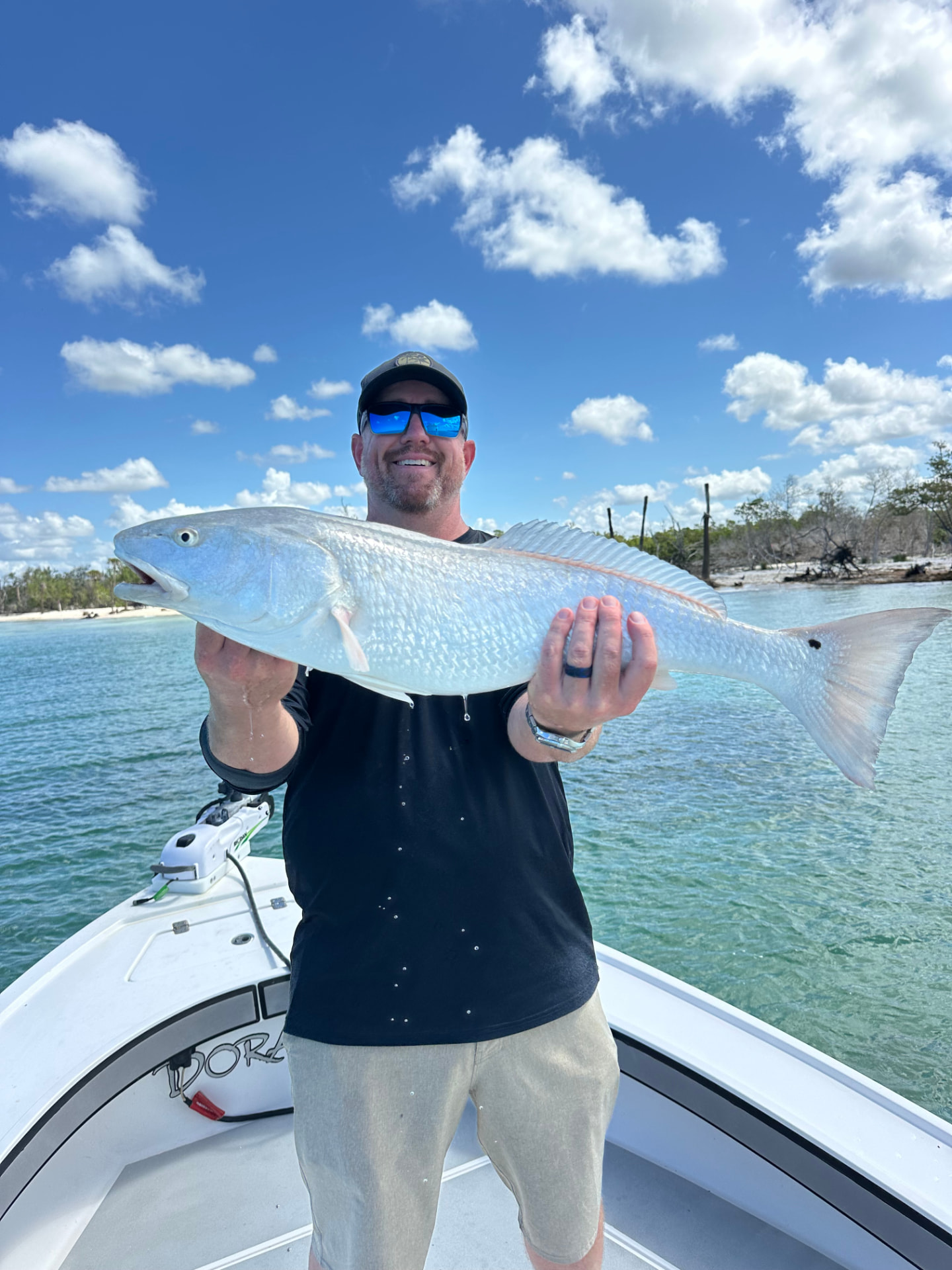 Angler with a bull redfish on a Naples backwater charter